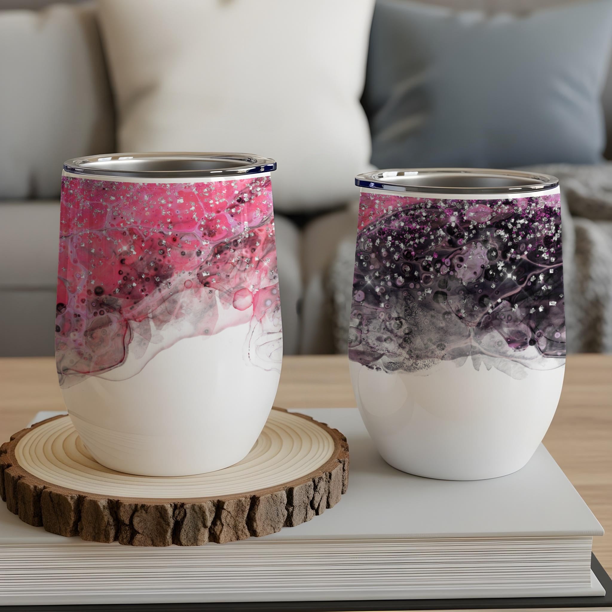 Two abstract patterned wine tumblers with pink and black swirls.