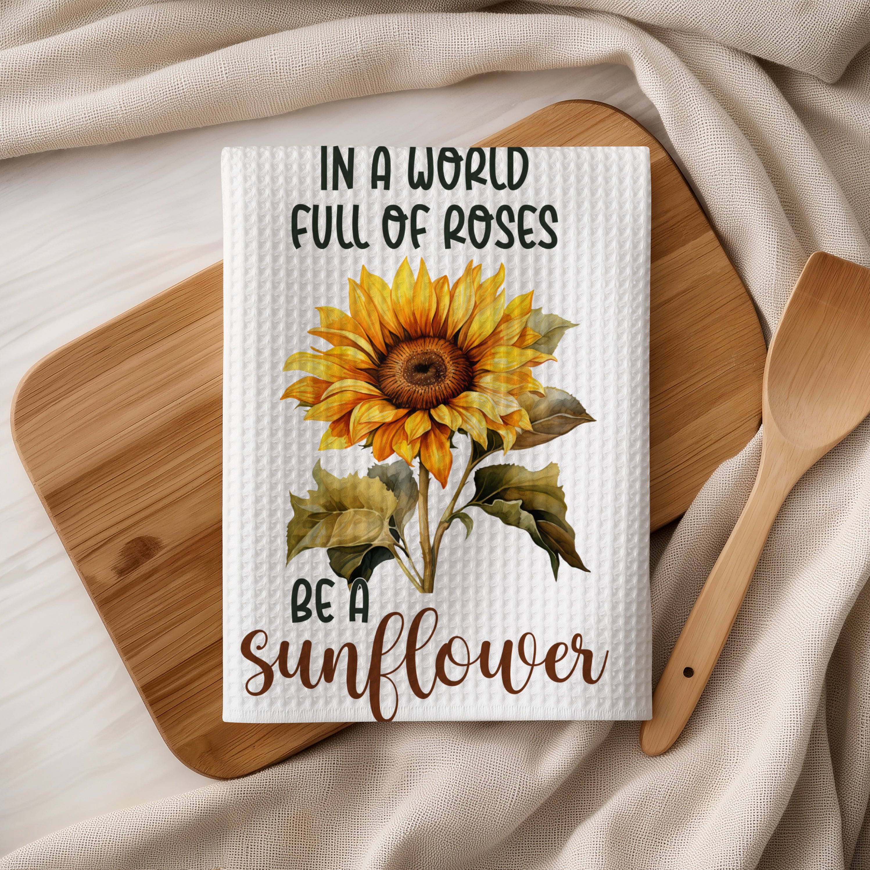 Tea towel with sunflower and text "In a world full of roses be a sunflower".