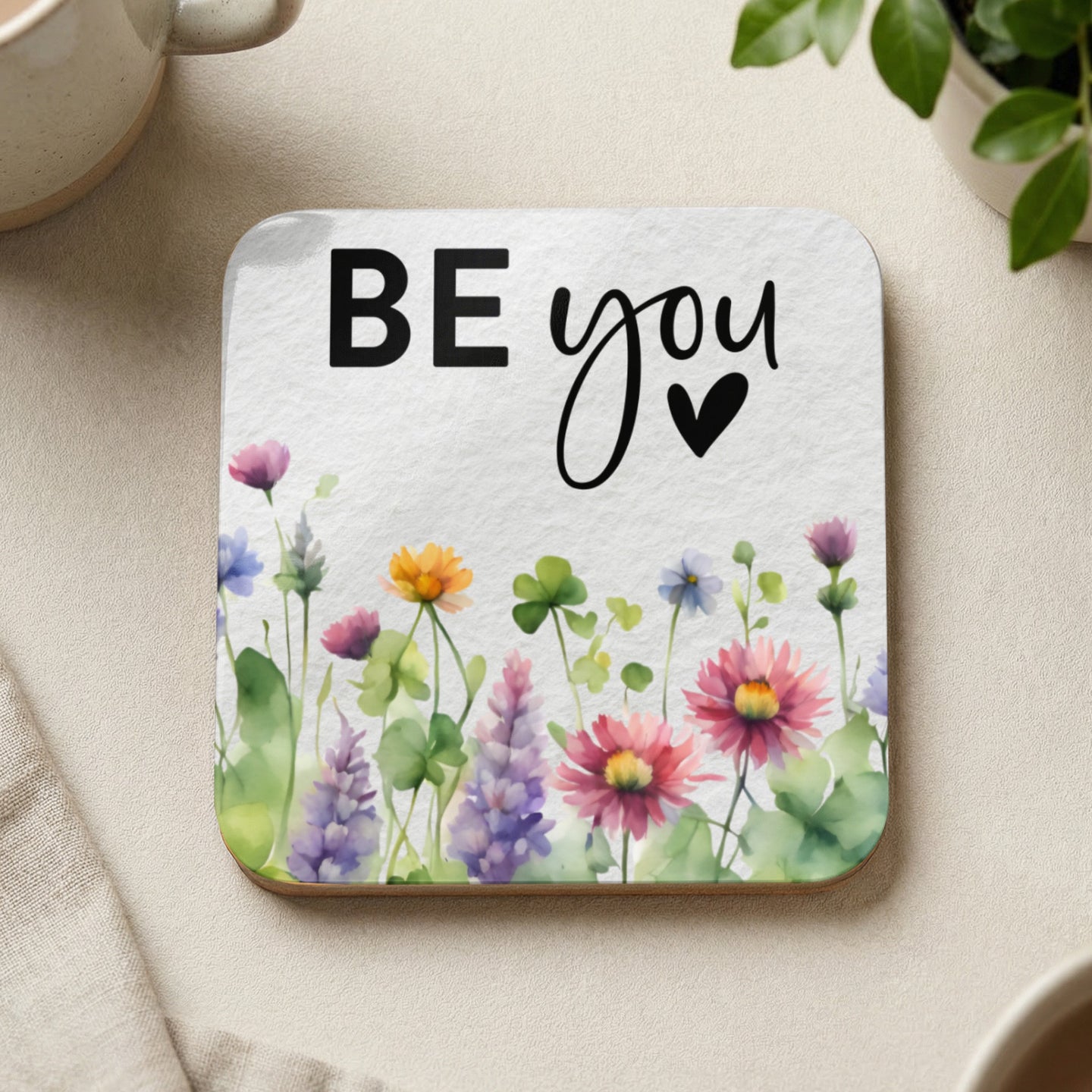 Coaster with "BE you" text and watercolor wildflowers.