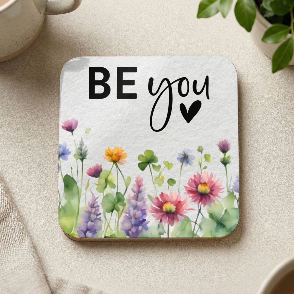 Coaster with "BE you" text and watercolor wildflowers.