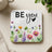 Coaster with "BE you" text and watercolor wildflowers.