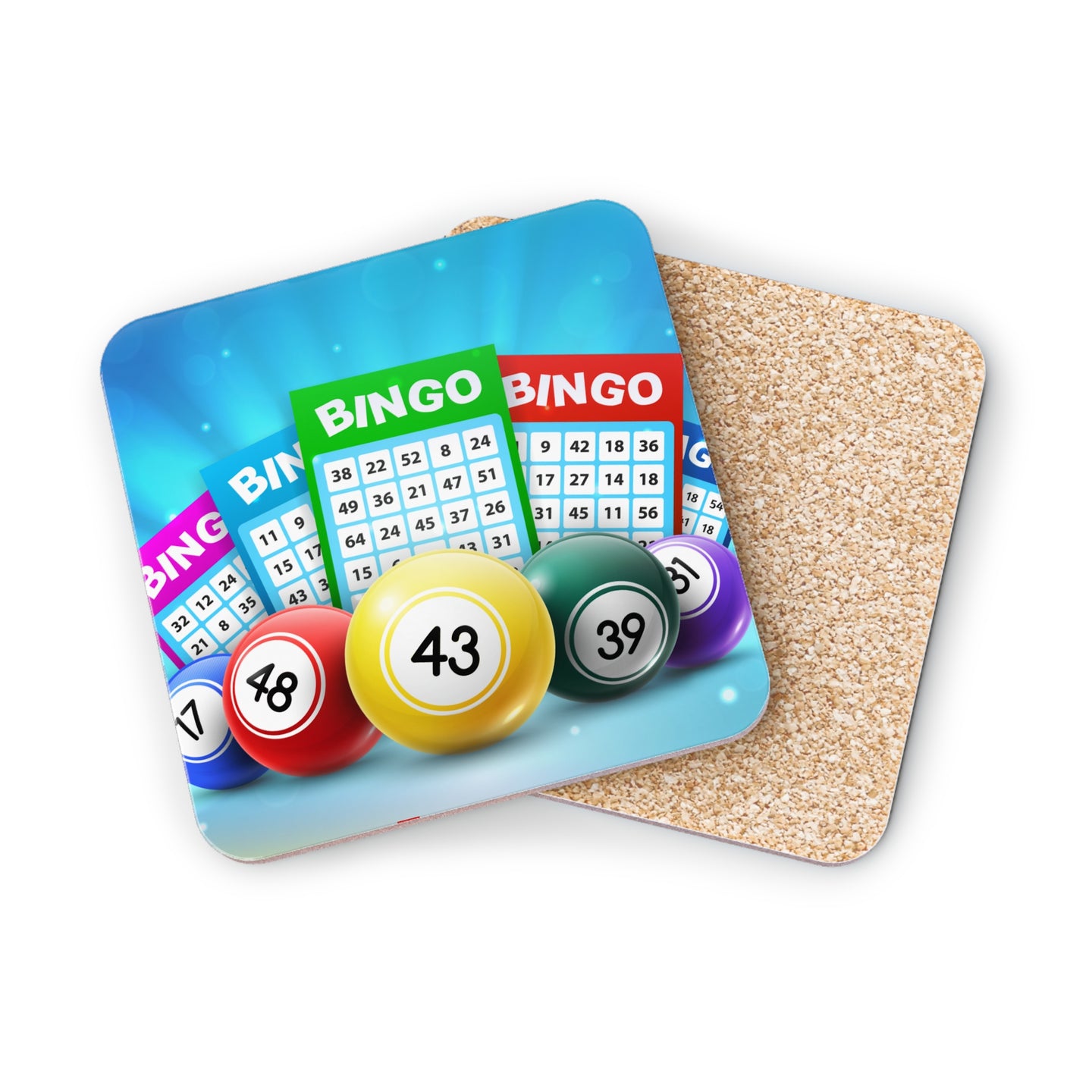 Bingo cards and numbered balls on a cork coaster.