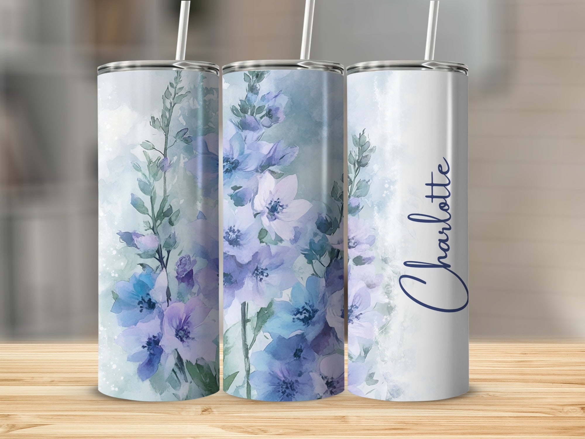 Tumbler with blue and purple watercolor floral design and "Charlotte" text.