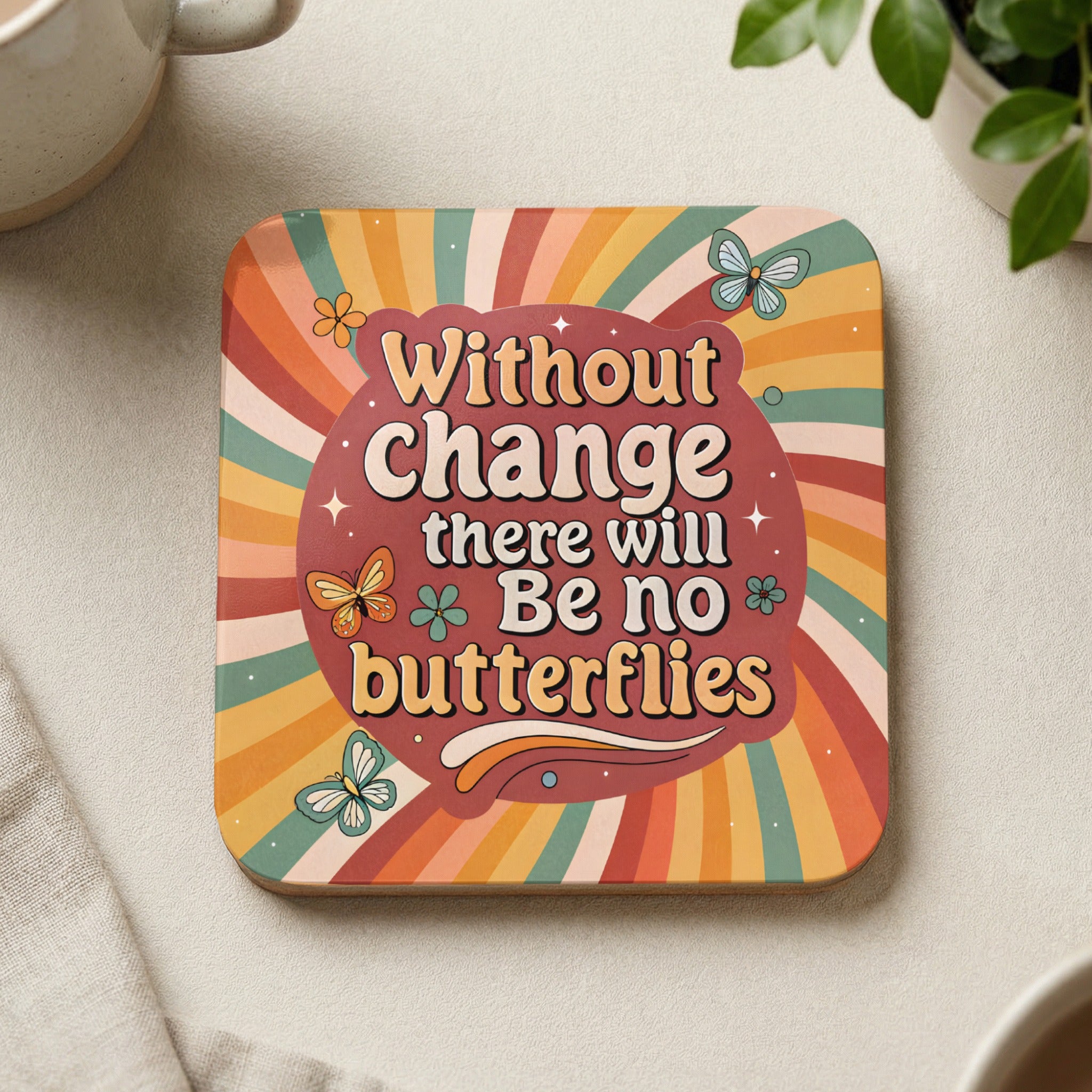 Square coaster with "Without change there will be no butterflies" and colorful floral design.