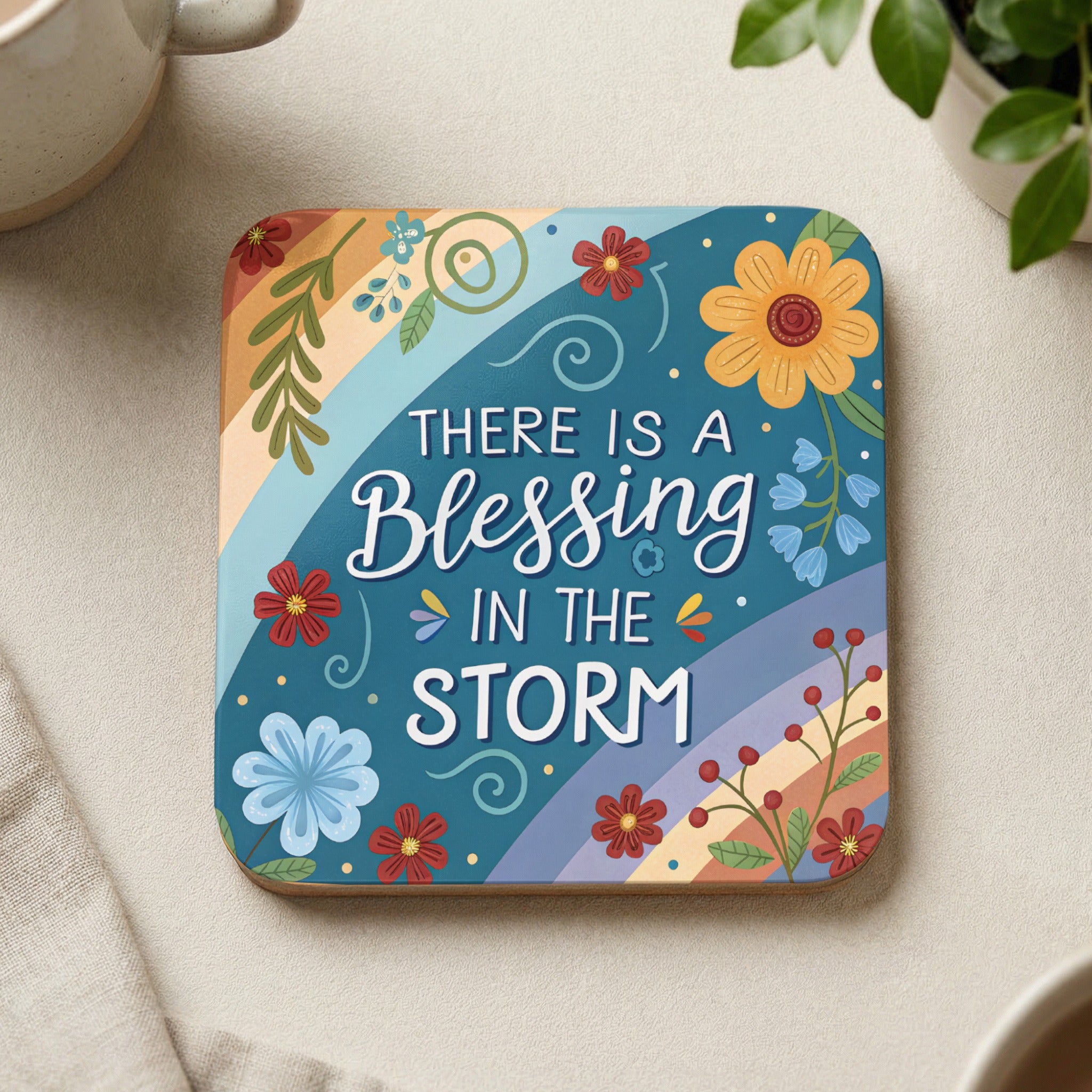 Square coaster with colorful floral design and "There is a blessing in the storm" text.