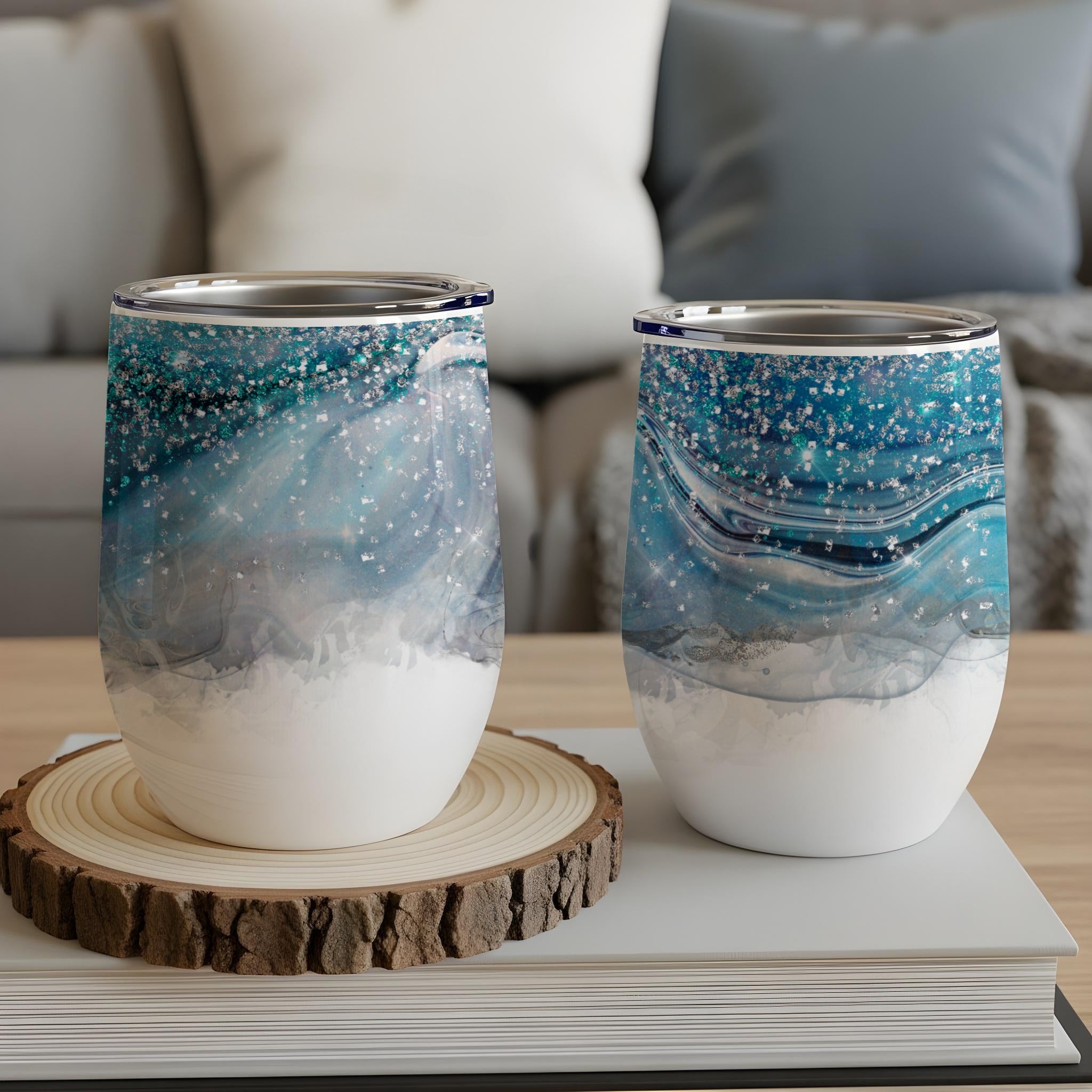 Two insulated tumblers with a swirling blue, gray, and silver glitter design.