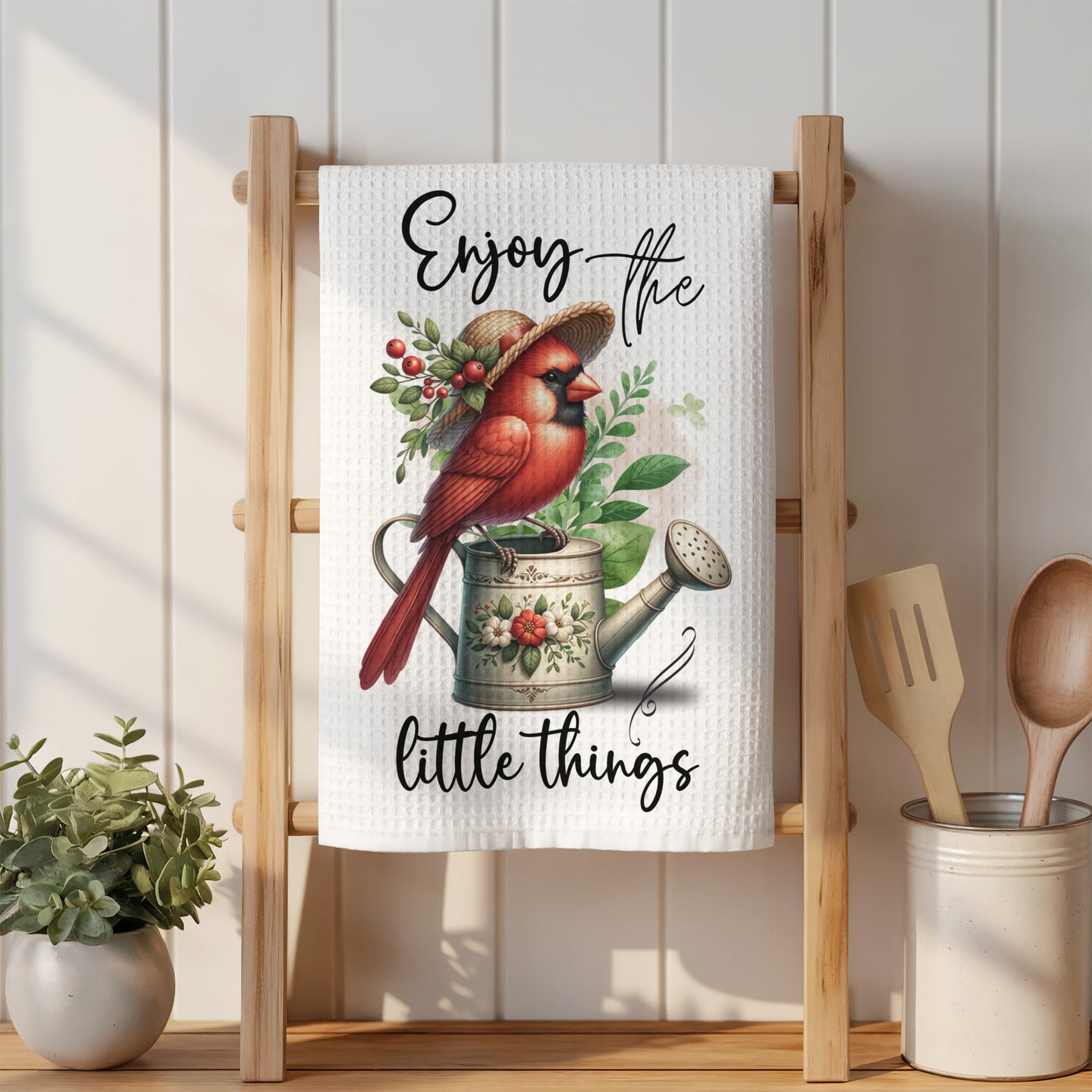 Cardinal on watering can with text "Enjoy the little things"