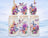 Three frosted glass tumblers with floral and butterfly designs.