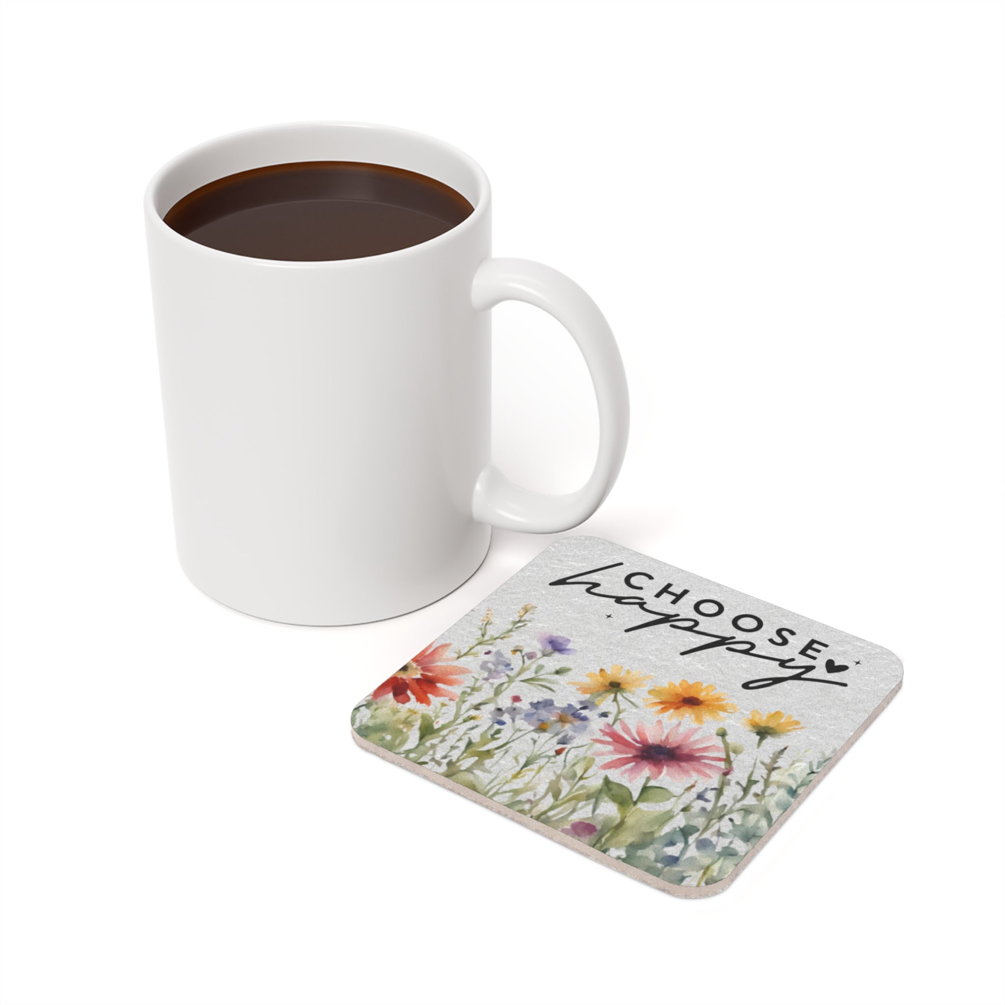 White mug of coffee next to square coaster with floral watercolor and text.