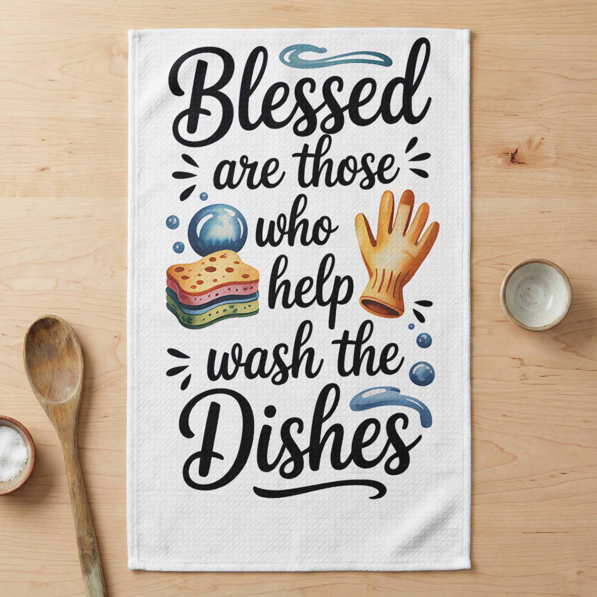 Blessed are those who help wash the dishes graphic on a kitchen towel.