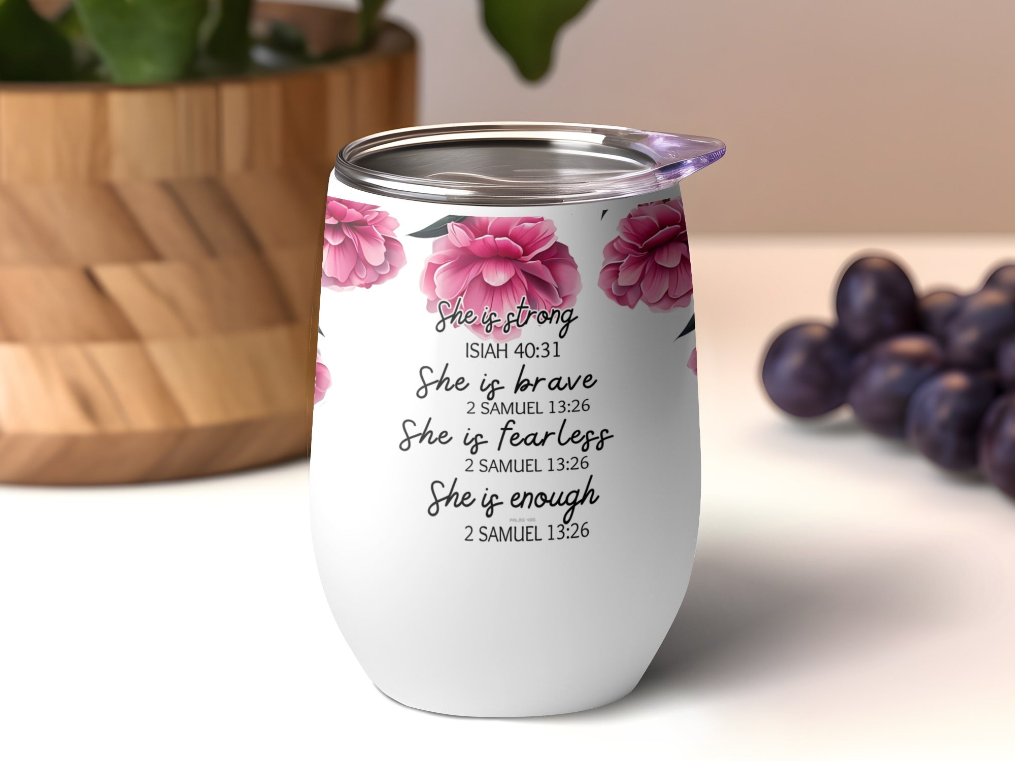 White tumbler with pink flowers and inspirational quotes in cursive.