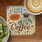 Coaster with "Less Talk More Coffee" text and latte art coffee.