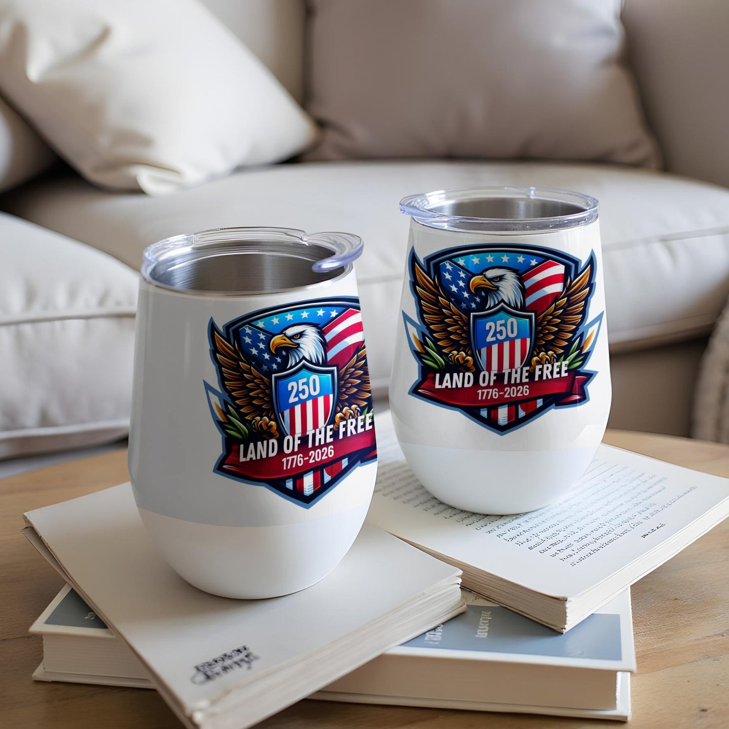 Two white tumblers with an eagle and "Land of the Free" emblem.