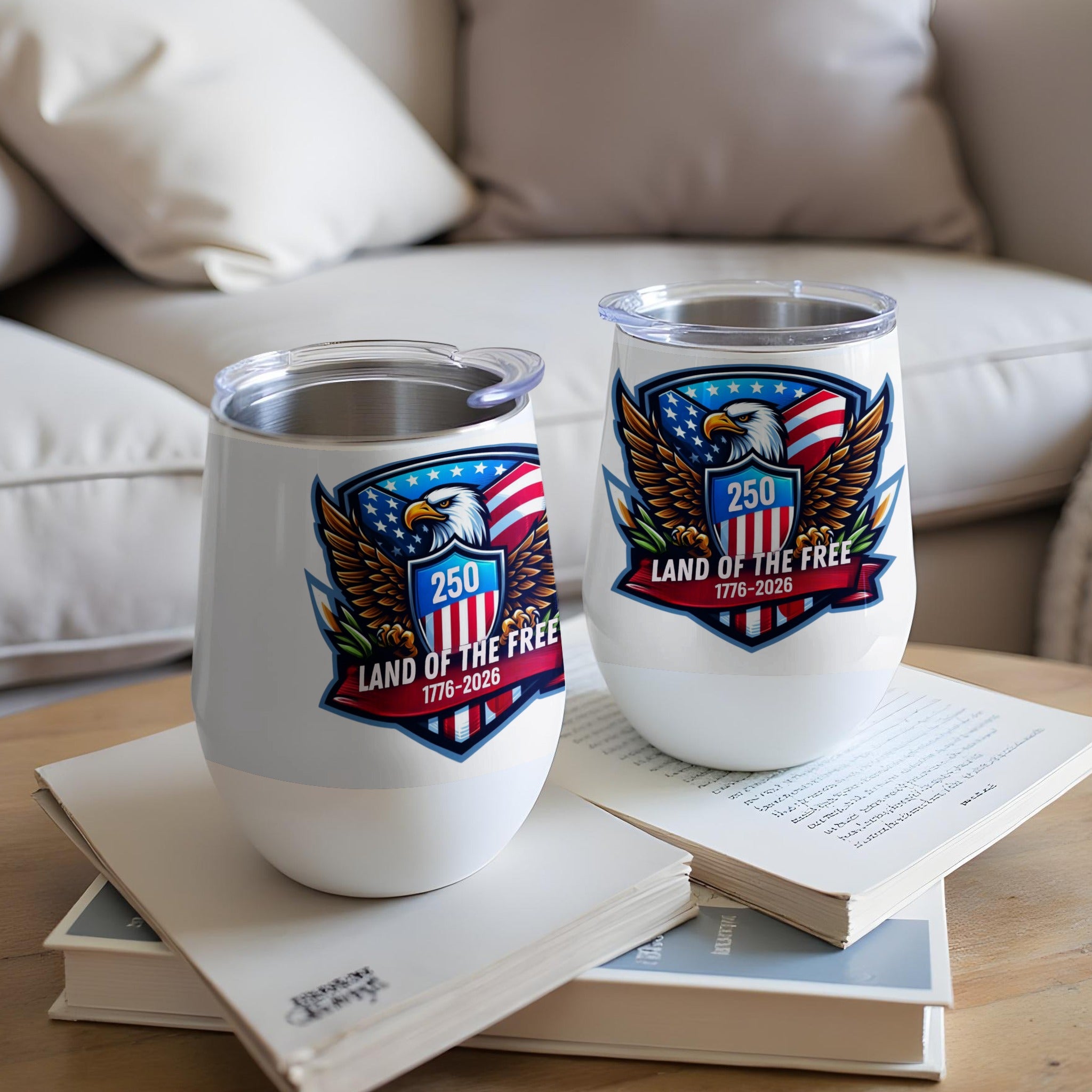 Two white tumblers with an eagle and "Land of the Free" emblem.