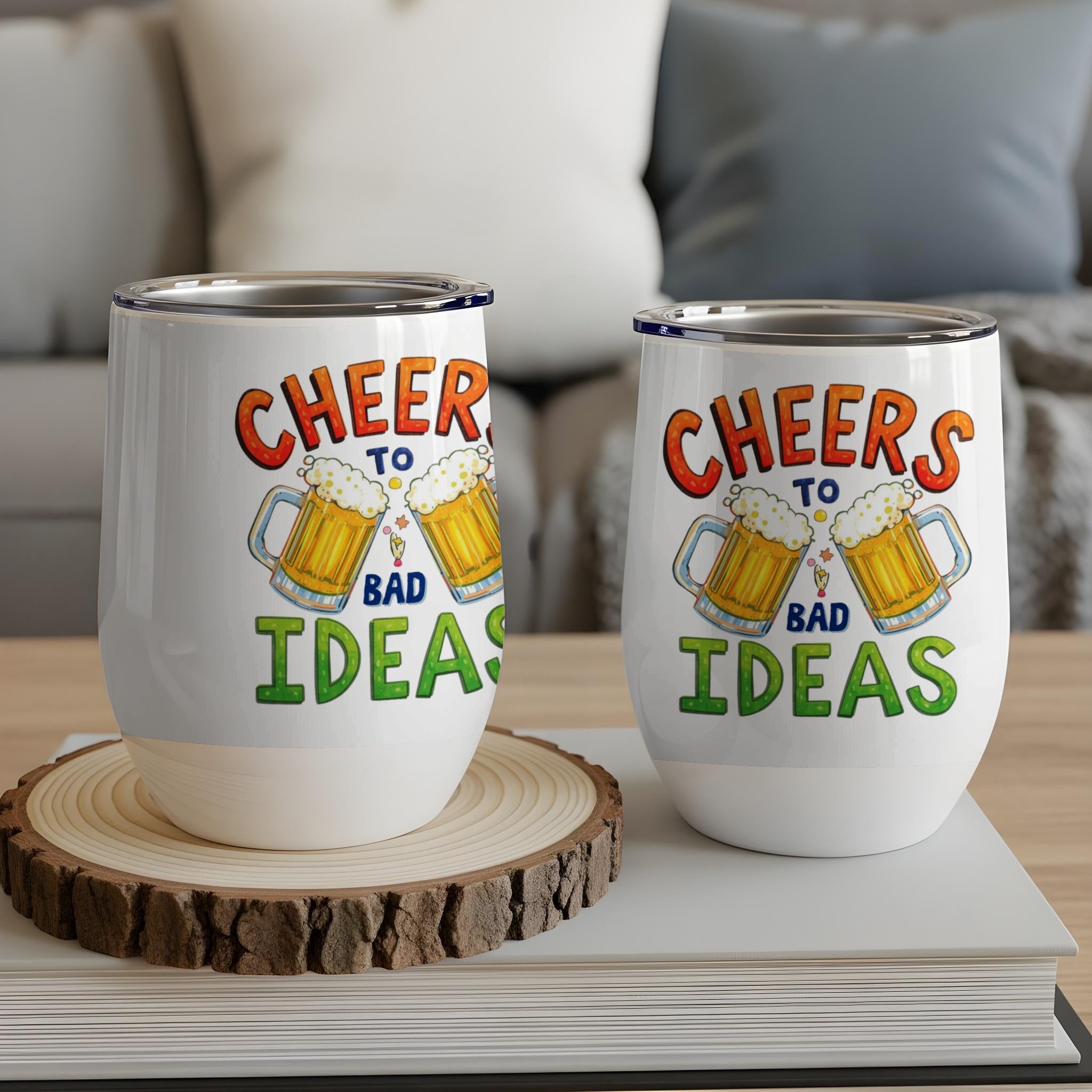Two white tumblers with "Cheers to Bad Ideas" and beer mugs graphic.