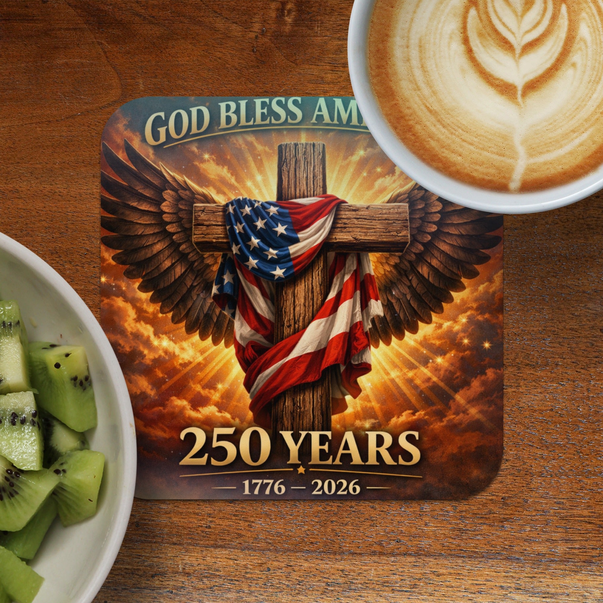 Cross with American flag draped, wings, and text "God Bless Am 250 Years 1776-2026".