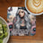 Tattooed woman with long grey hair on a coaster with floral background and text.