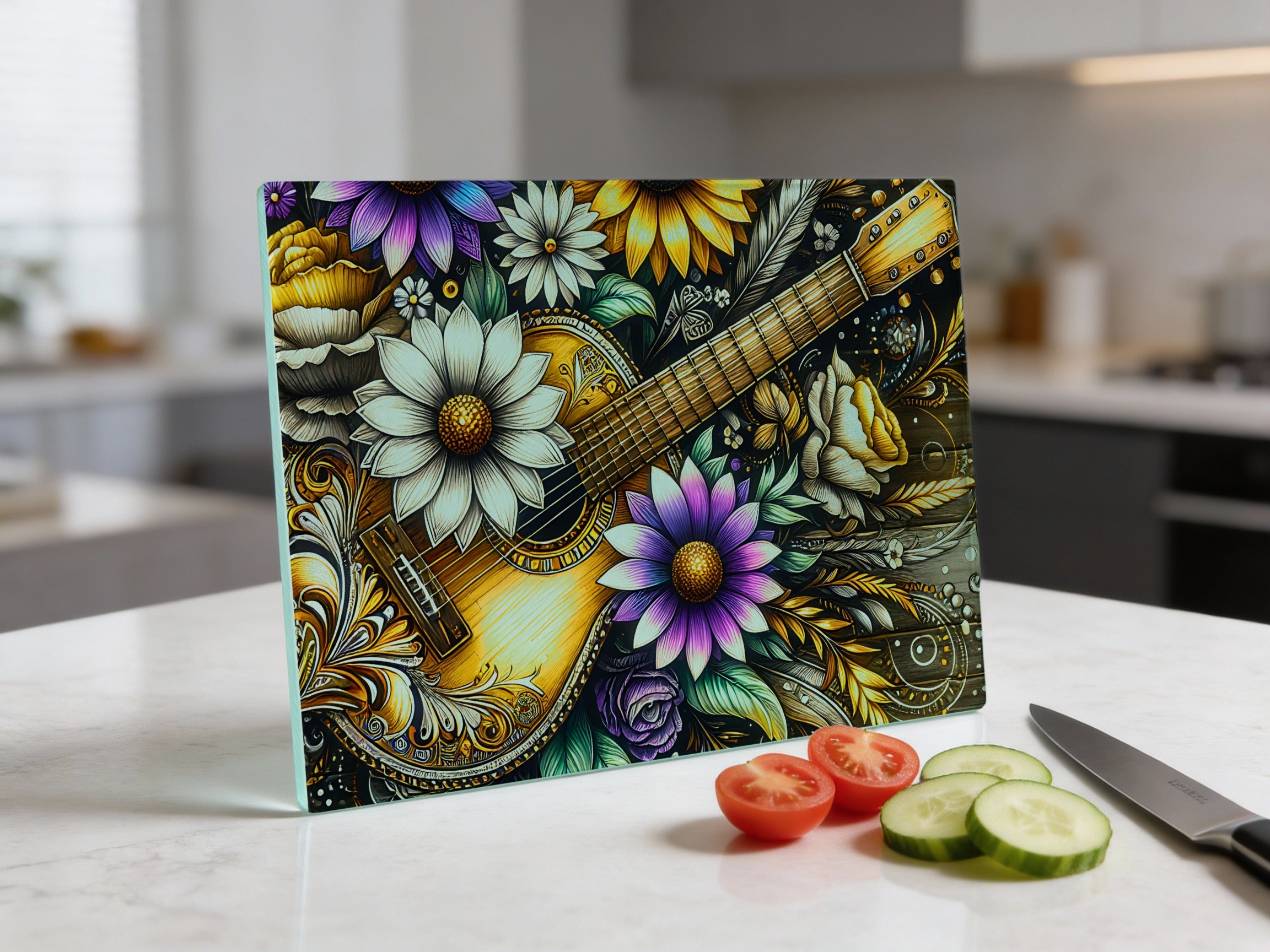 Glass cutting board with floral and guitar design, sliced tomatoes, and cucumber.