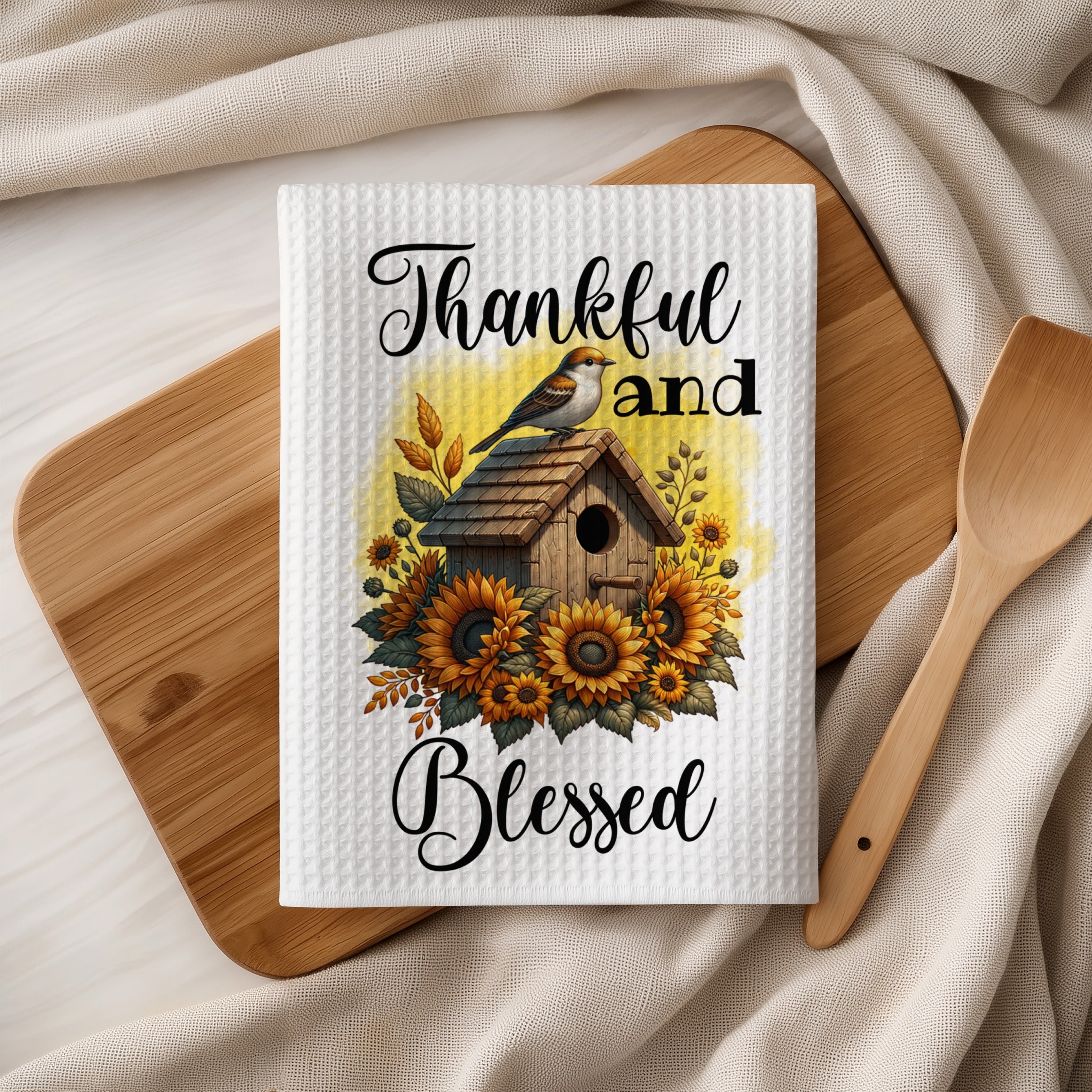 Kitchen towel with birdhouse, sunflowers, and text "Thankful and Blessed".