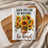 Text reads: When you can be anything, be kind. Sunflowers in vase on white waffle towel.