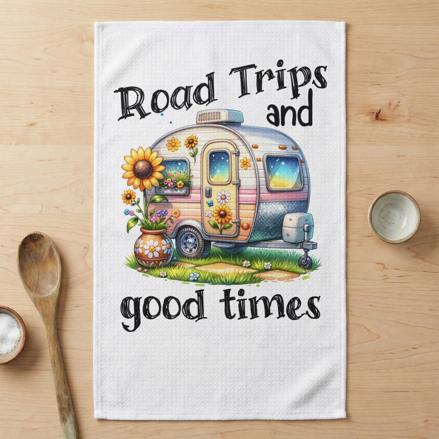 Camper trailer with sunflowers and text "Road Trips and good times".