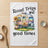 Camper trailer with sunflowers and text "Road Trips and good times".