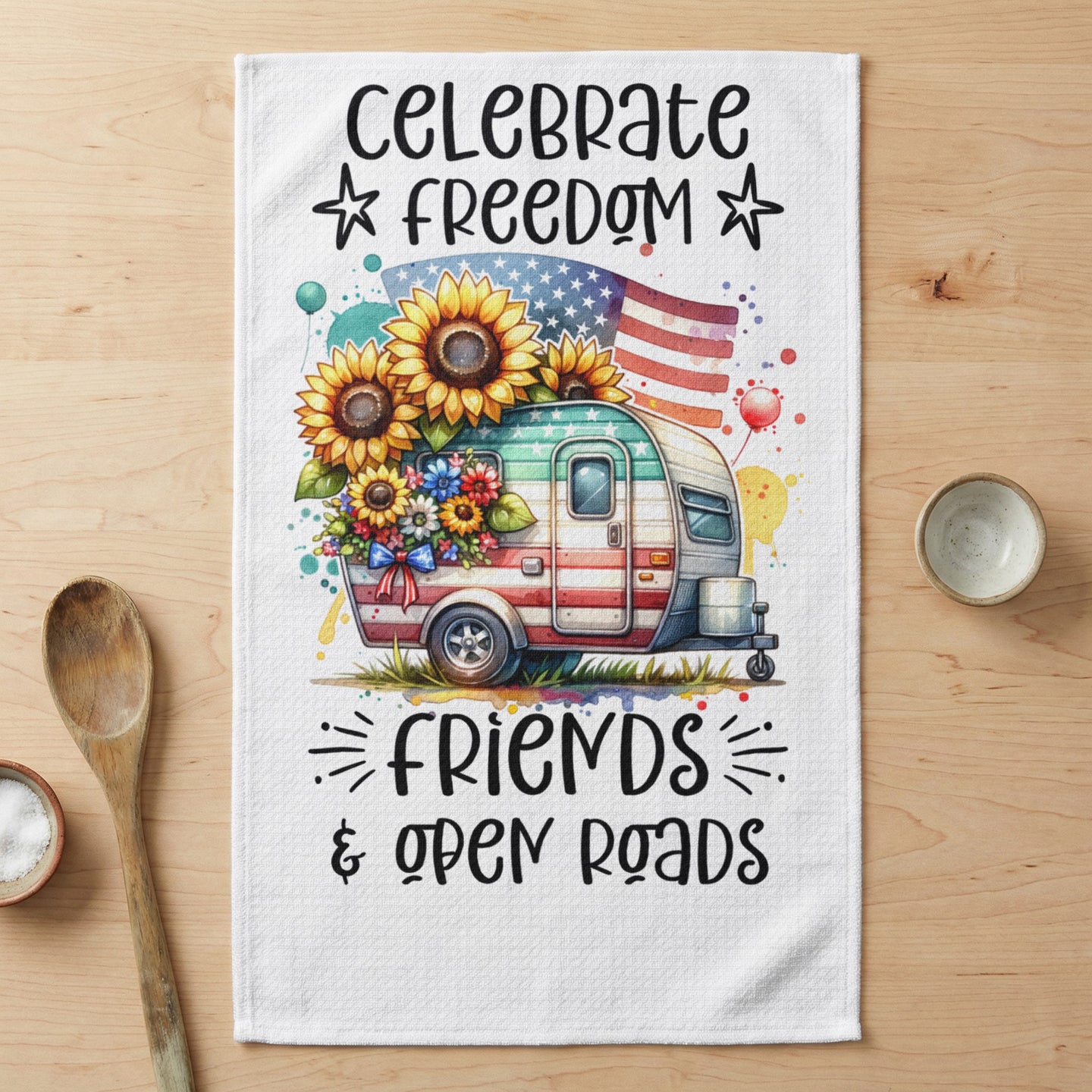 Camper with sunflowers, American flag, and text "Celebrate Freedom & Open Roads."