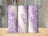Purple and white patterned tumblers with "Madison" text on a wooden surface.