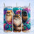 Three fluffy cats in colorful floral art, one orange, one brown, one black.