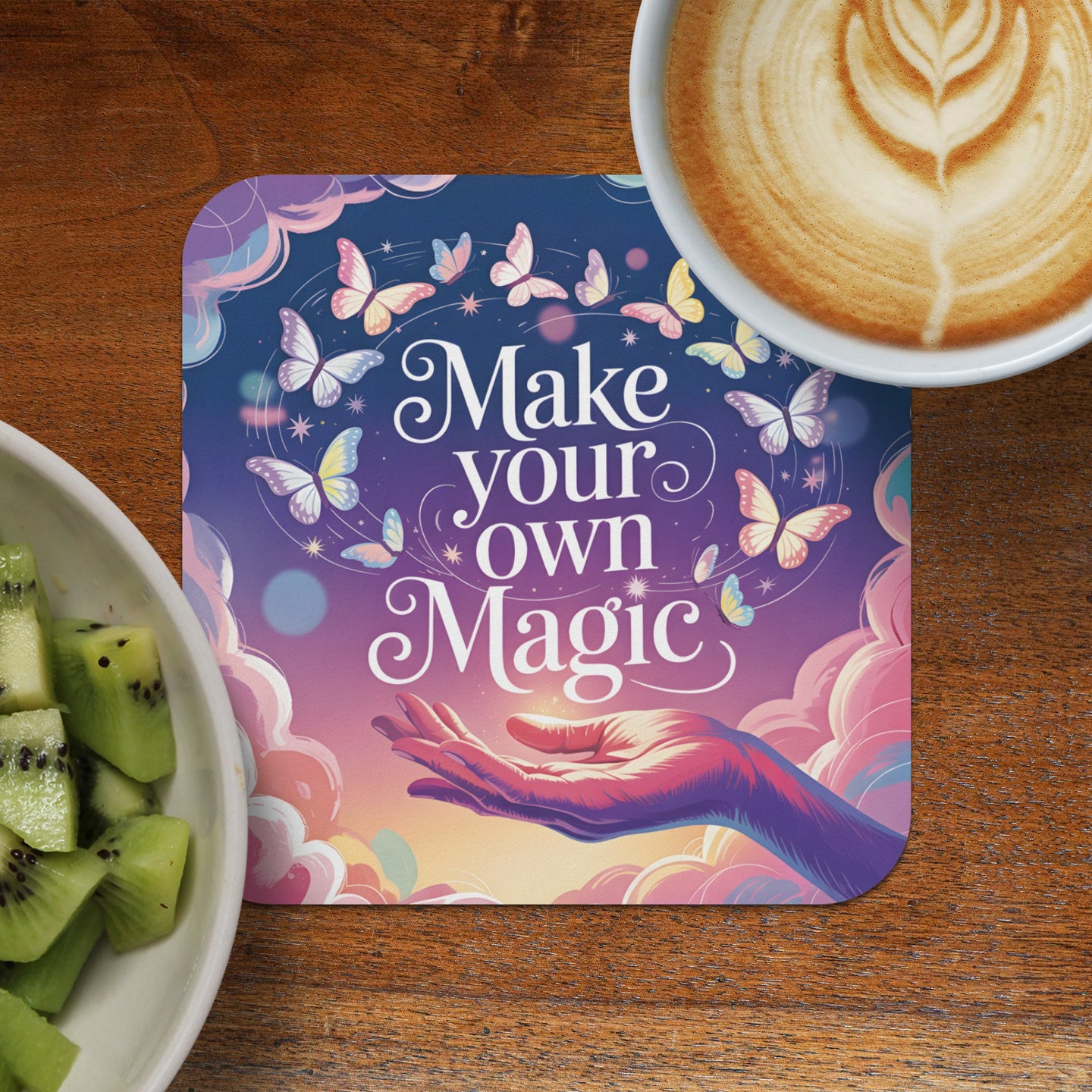 Coaster with hand reaching up to make butterflies, reads "Make your own Magic."