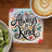 Always be kind sentiment on coaster with coffee and kiwi fruit.