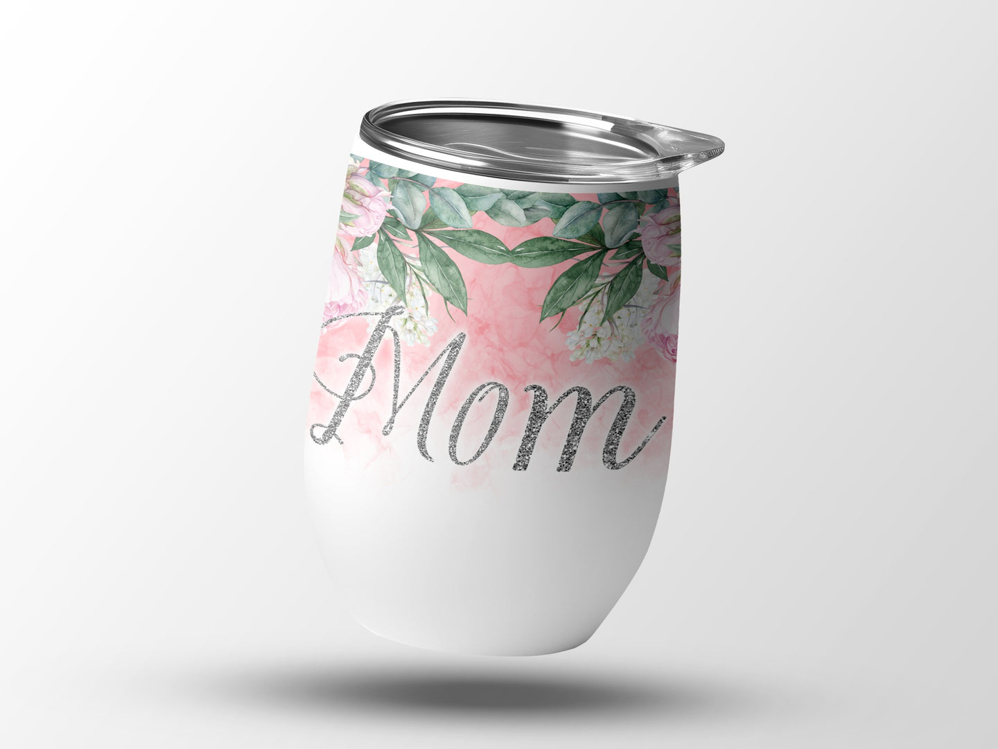 White tumbler with pink floral design and glitter "Mom" text.
