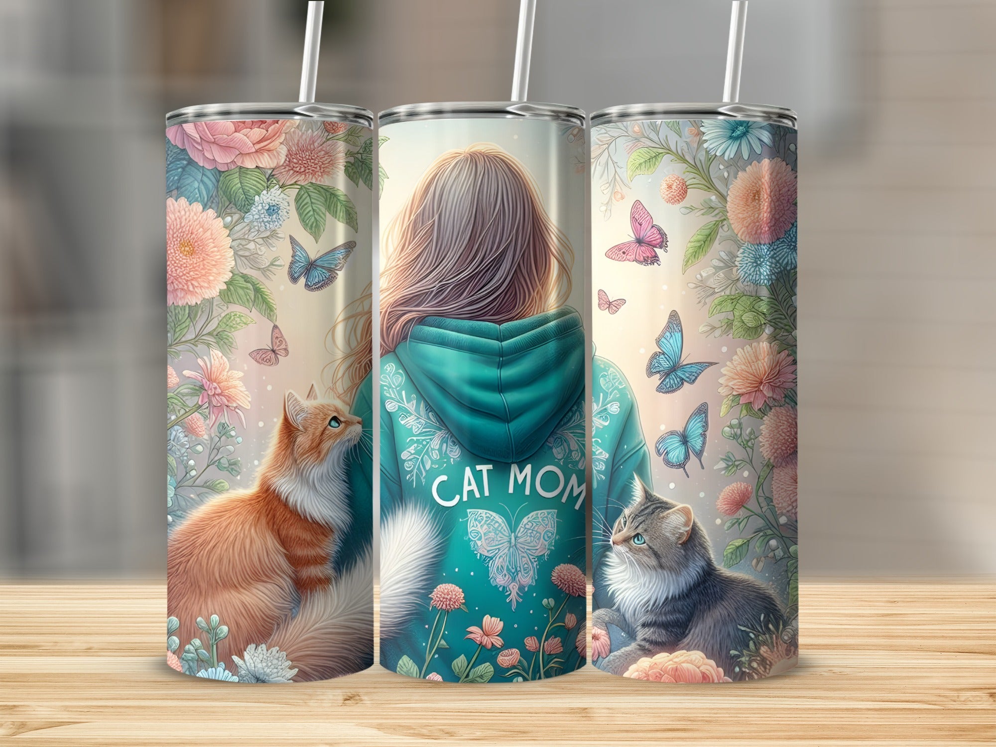 Three tumblers with floral and butterfly designs featuring a "Cat Mom" graphic.