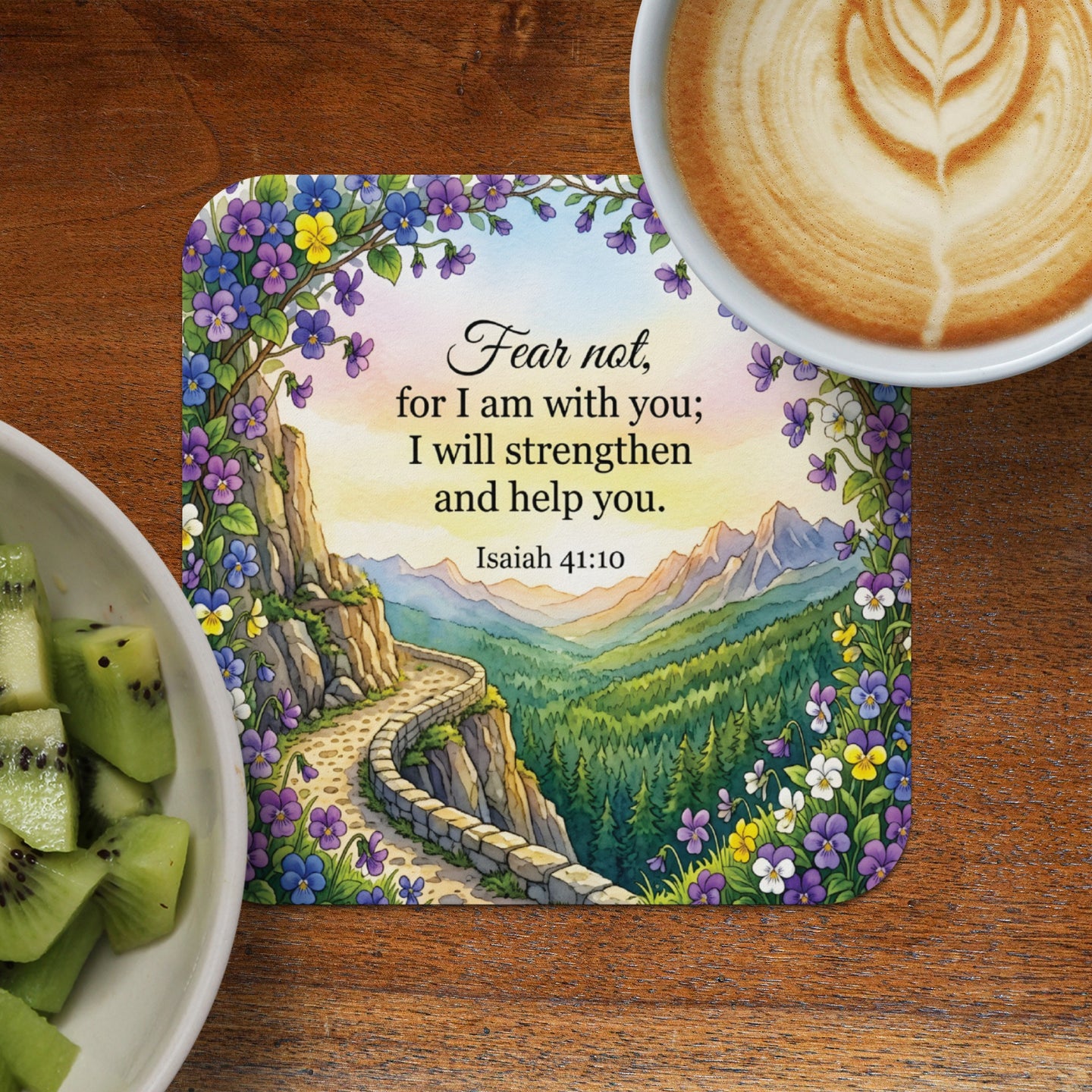 Coaster with floral border and Isaiah 41:10 scripture over mountain landscape.