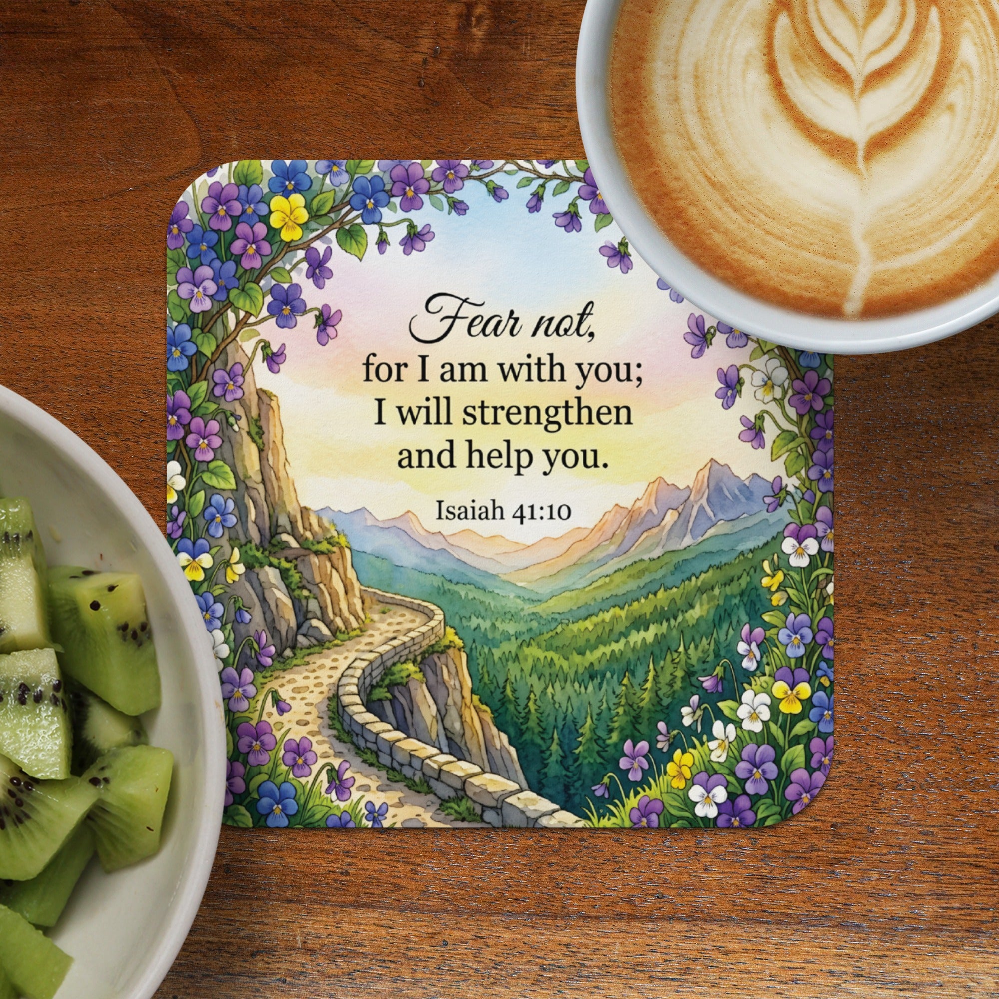 Coaster with floral border and Isaiah 41:10 scripture over mountain landscape.