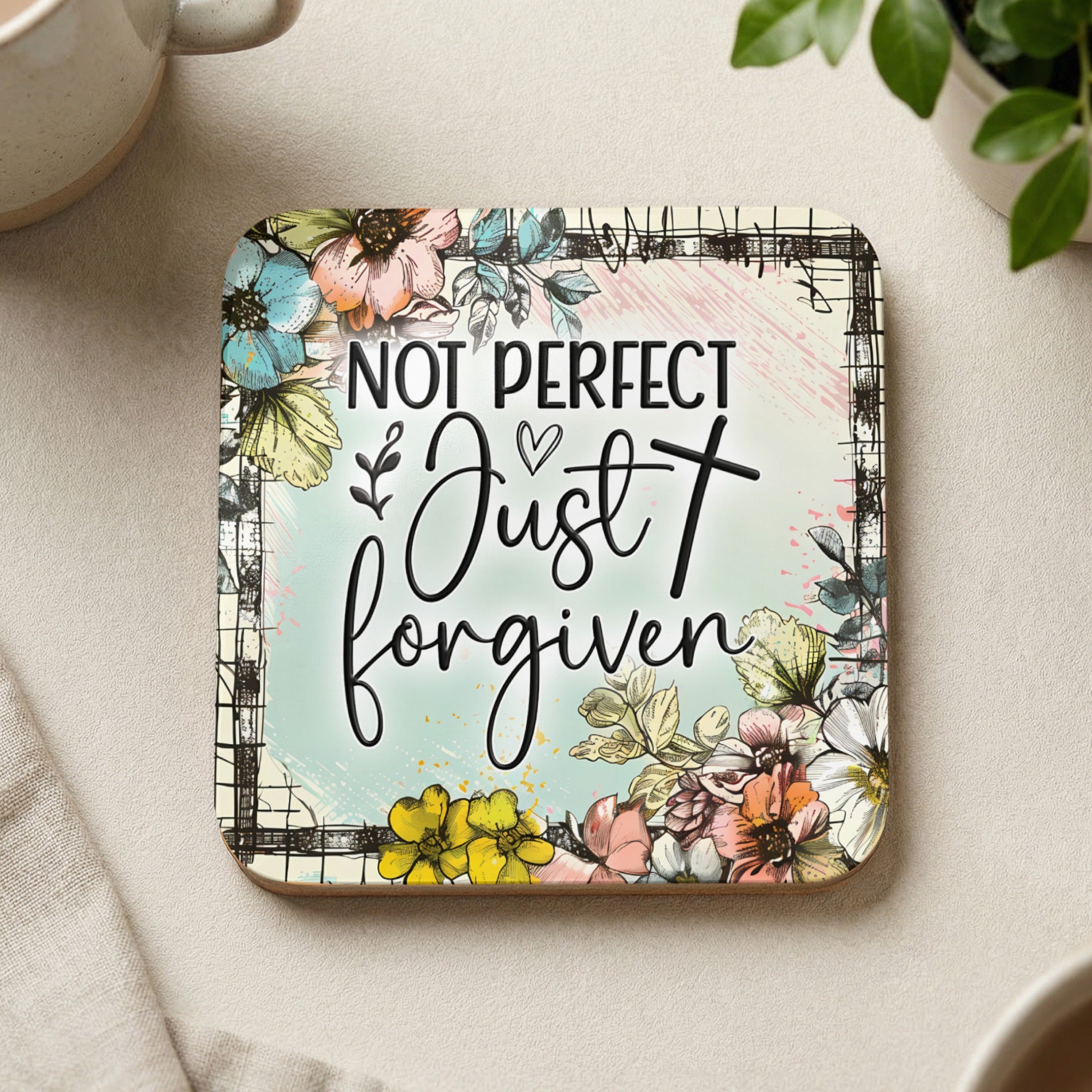 Coaster with floral design and text "Not perfect, just forgiven".