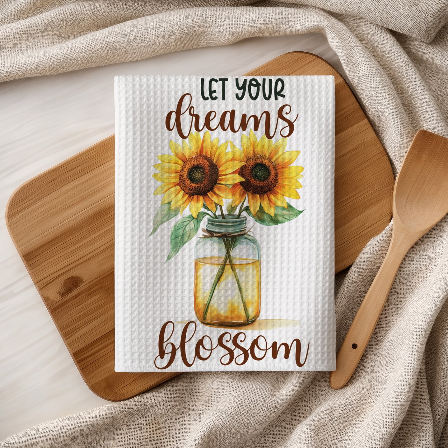 White tea towel with sunflowers in a jar and text "LET YOUR DREAMS BLOSSOM".