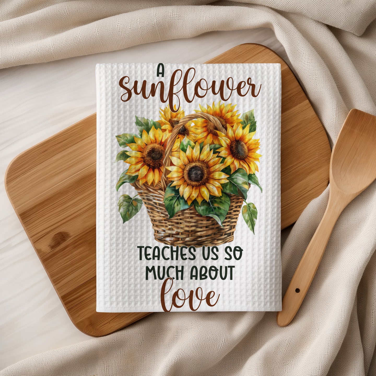Waffle weave towel with sunflowers in a basket and text reading "A sunflower teaches us so much about love".