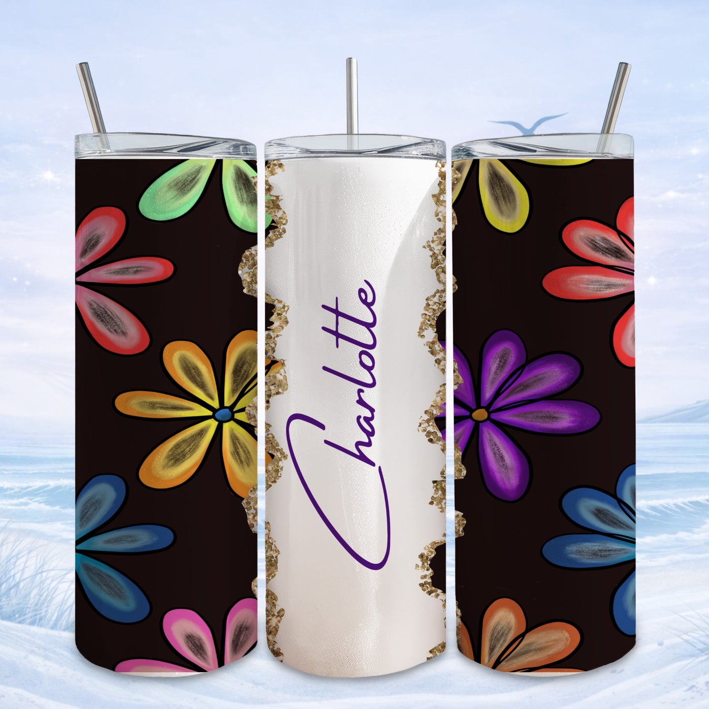 Tumbler with colorful floral pattern and "Charlotte" in gold glitter.