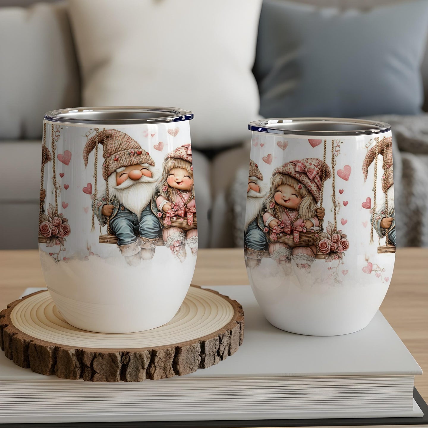 Two gnome couple mugs with hearts and floral designs, on a wooden coaster.