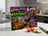 Grill Boss Snack Bandit graphic on tempered glass cutting board with burgers and grill.