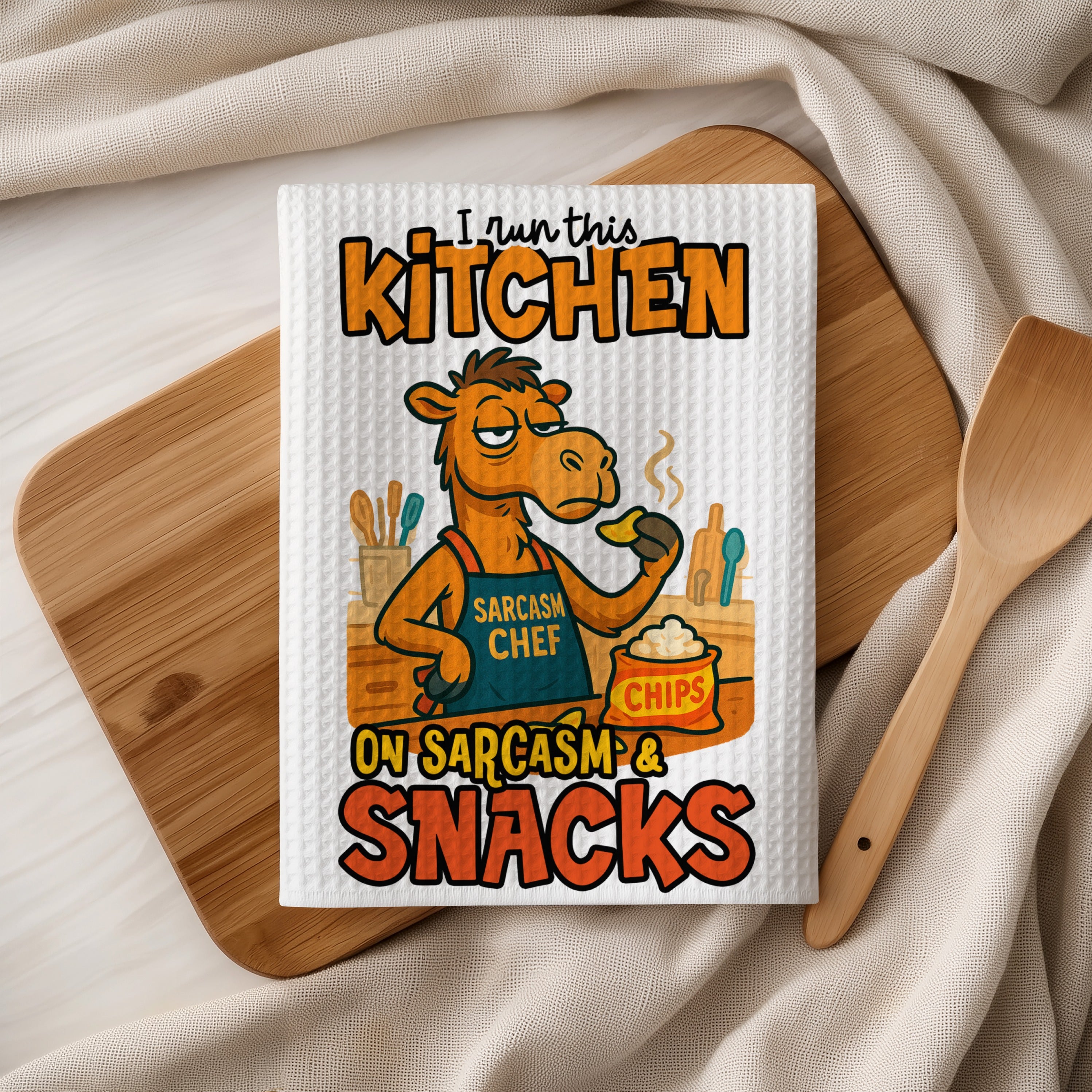 Camel chef wearing apron and holding chips, with text "I run this kitchen on sarcasm & snacks."