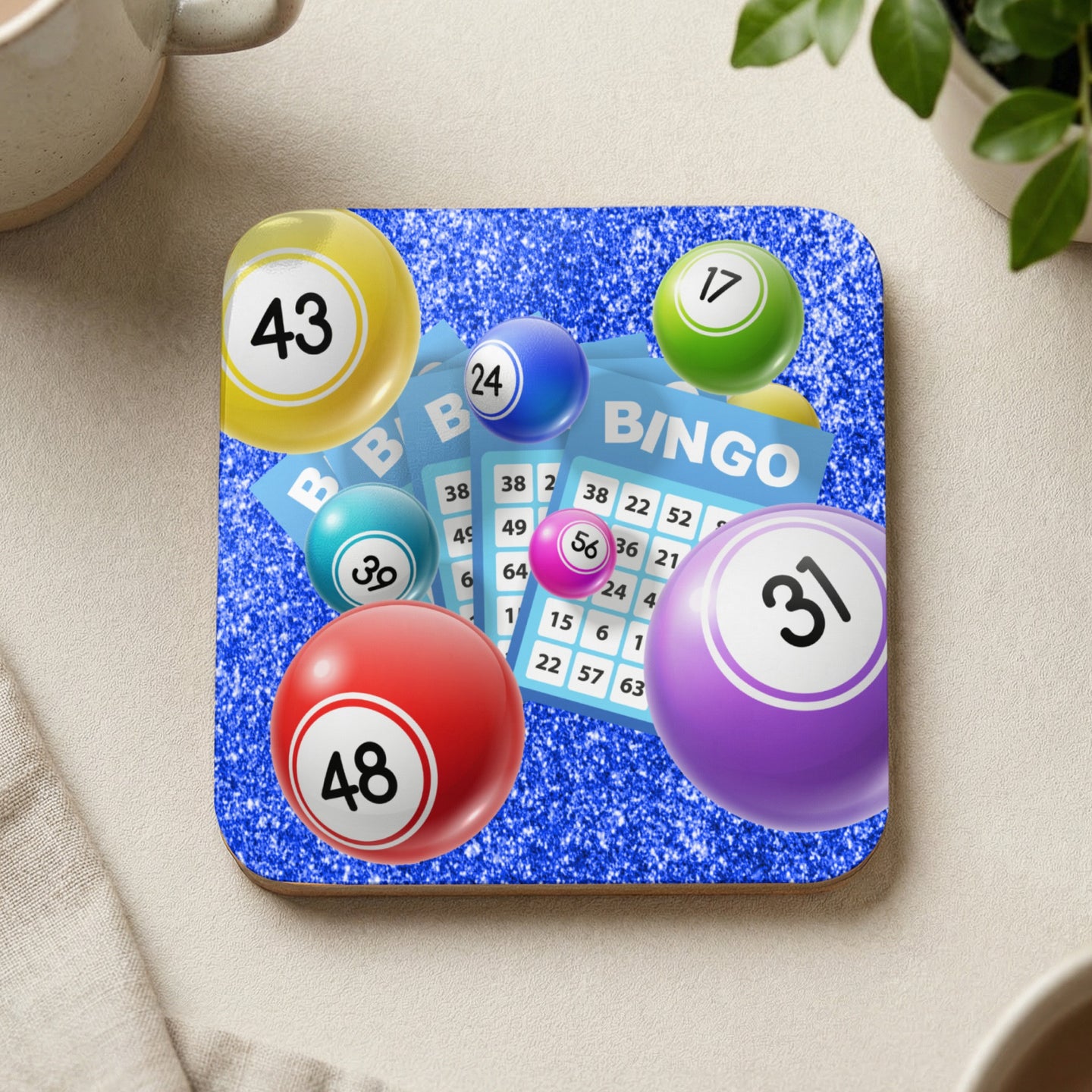 Bingo balls and a bingo card with numbers against a sparkly blue background.