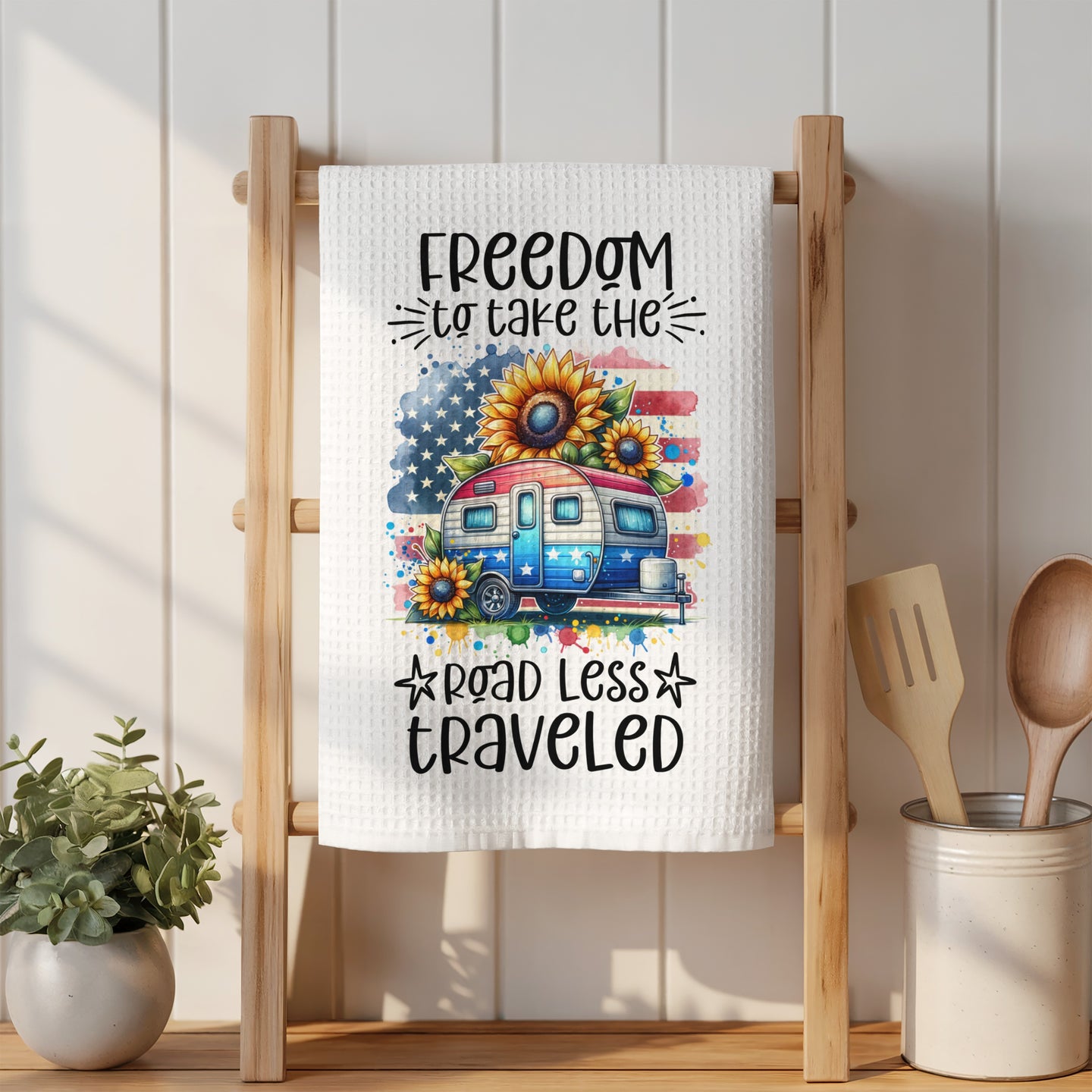Towel with camper, US flag, sunflowers, and "Freedom to take the road less traveled."