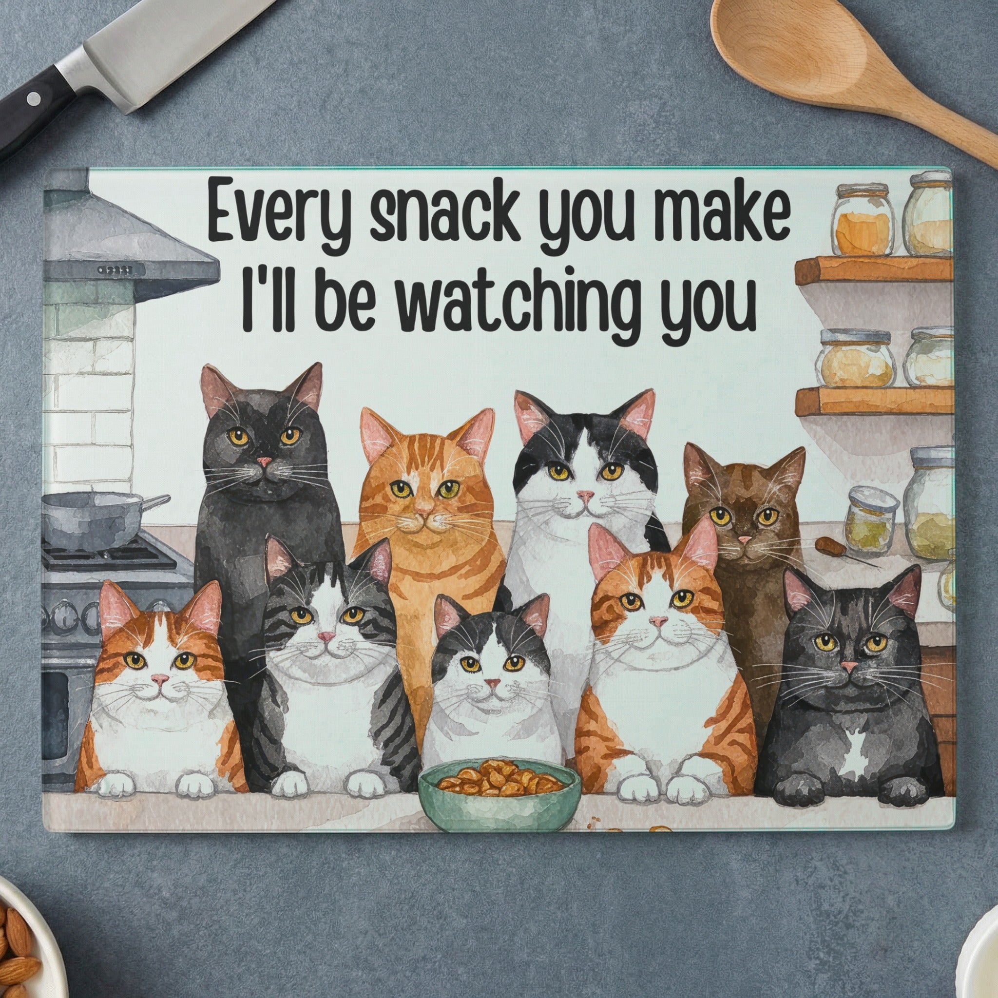 Ten cats watch a bowl of food under the text "Every snack you make I'll be watching you".