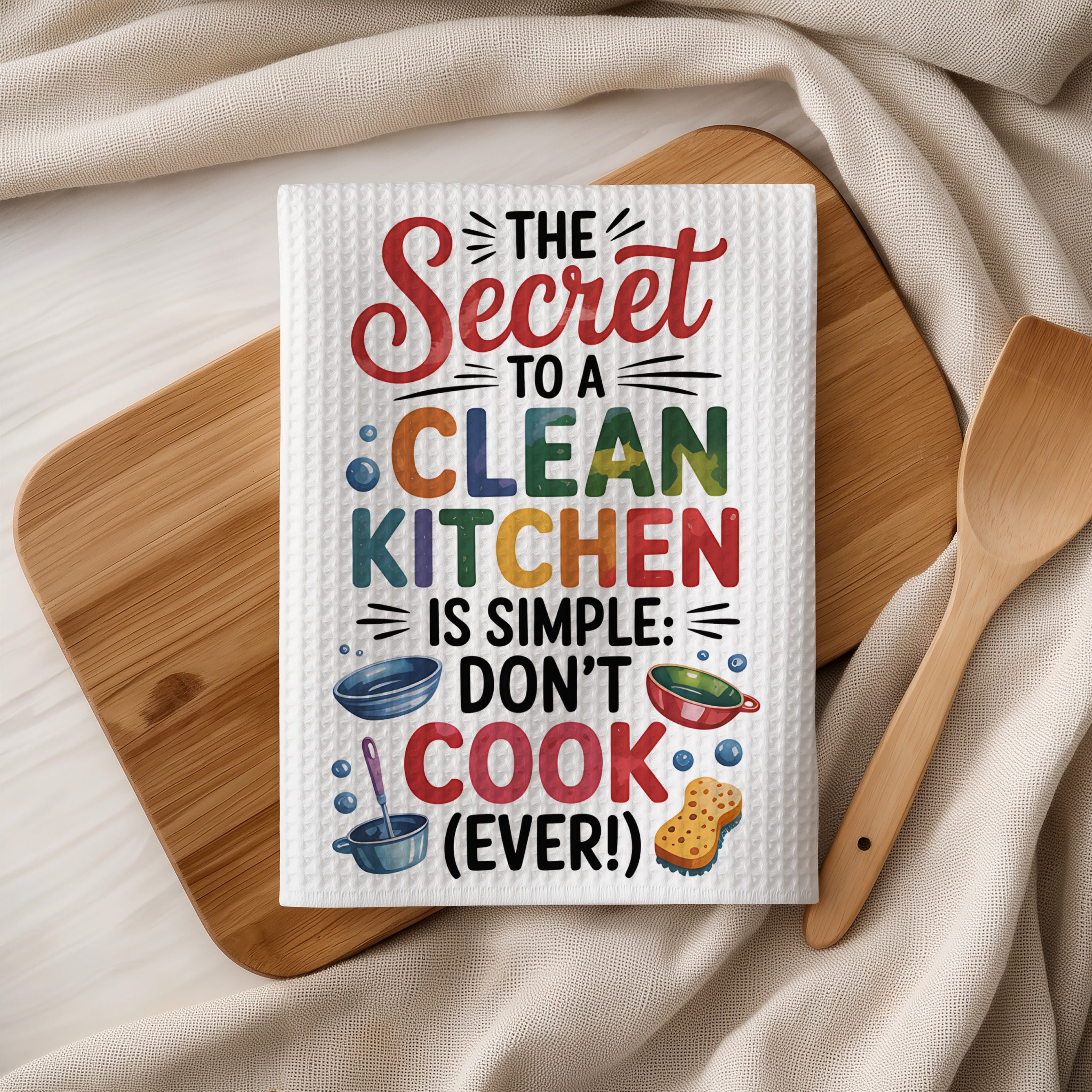 Towel with "The Secret to a Clean Kitchen is Simple: Don't Cook" text.