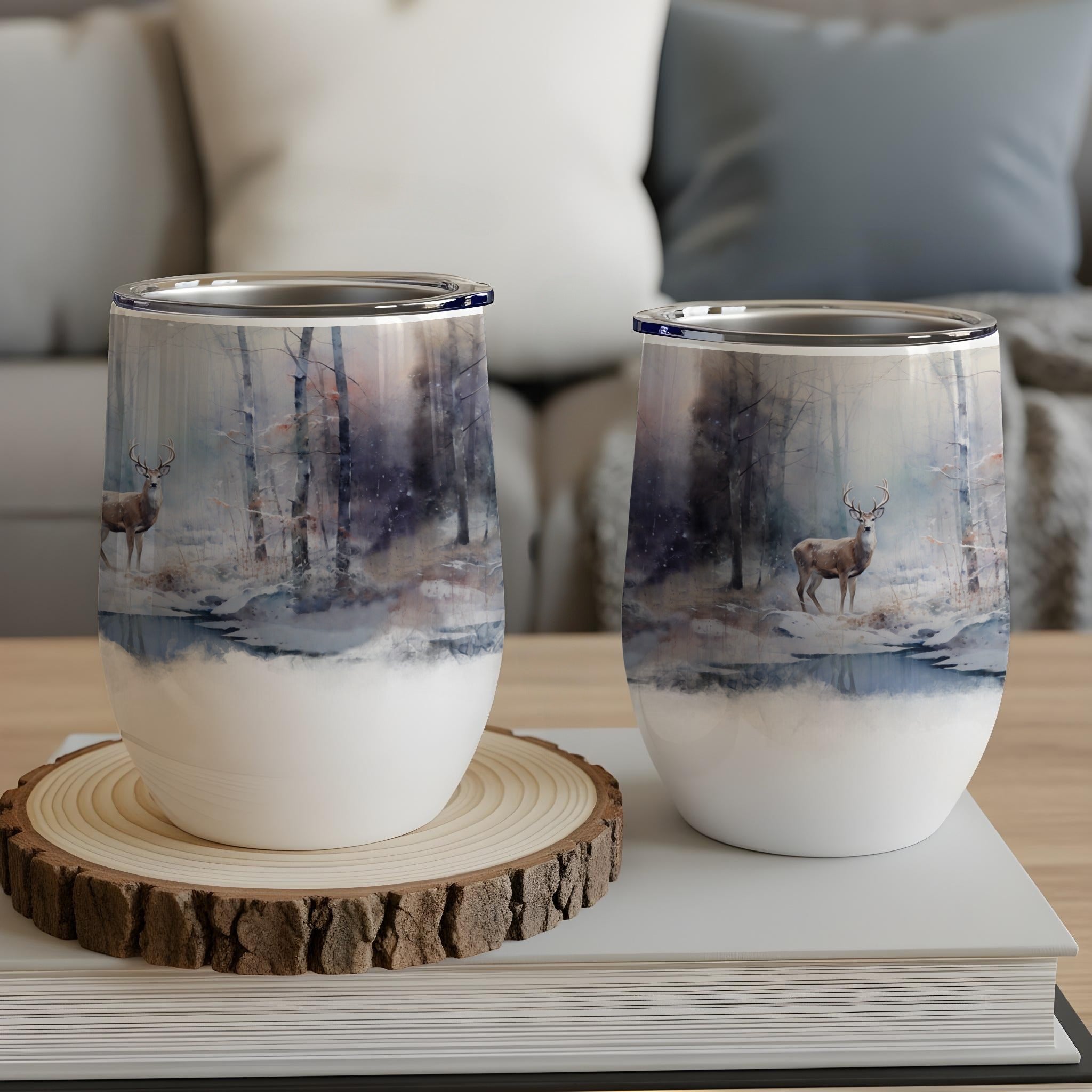 Two deer in a snowy forest scene on insulated wine tumblers.