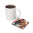 White mug with coffee next to a coaster featuring a woman and butterflies.