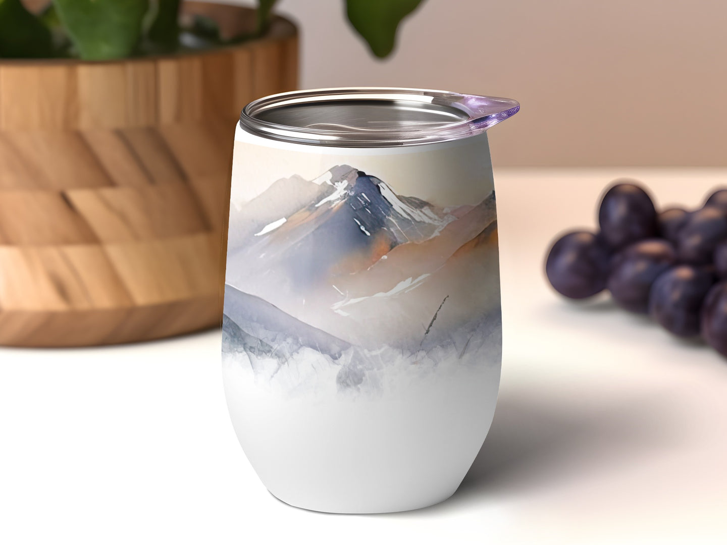 Stemless tumbler with mountain landscape design.