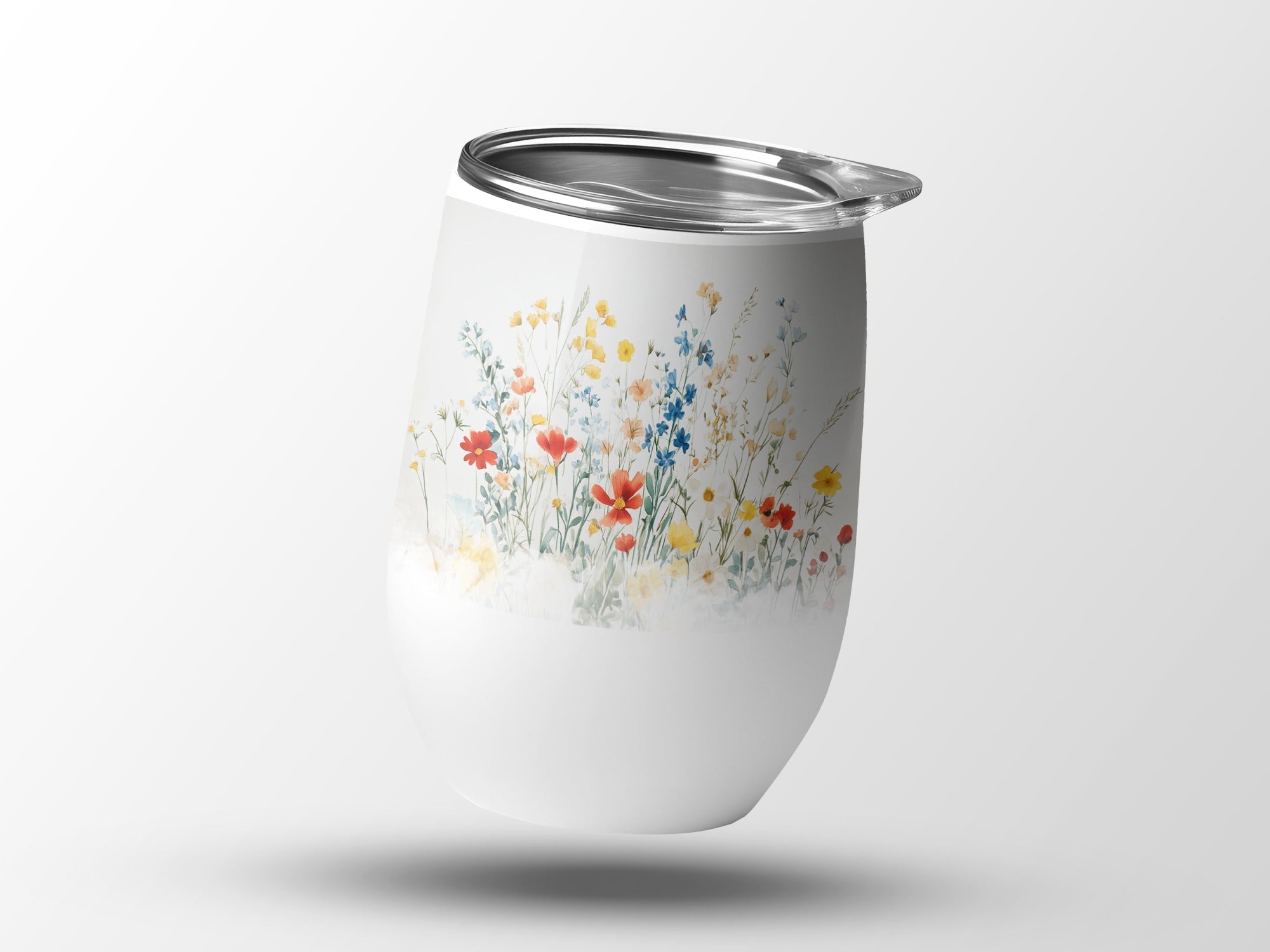 White tumbler with a watercolor wildflower floral pattern.